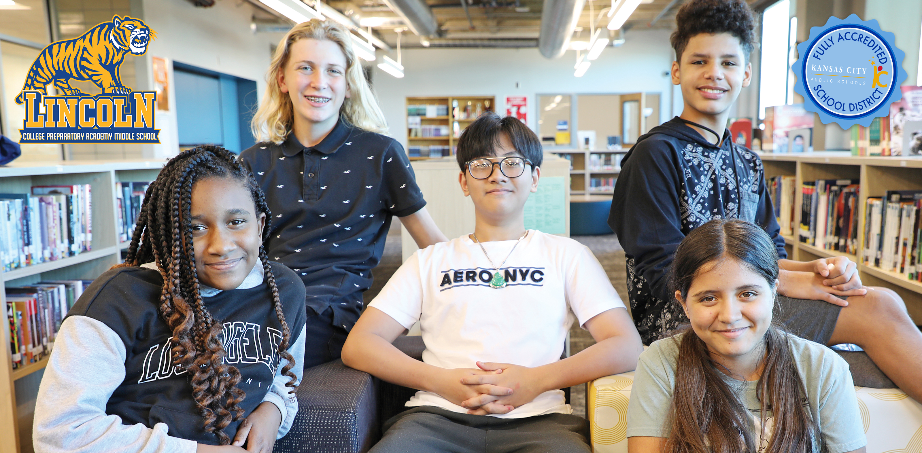 Happy LMS kids in the LMS library with LMS Logo